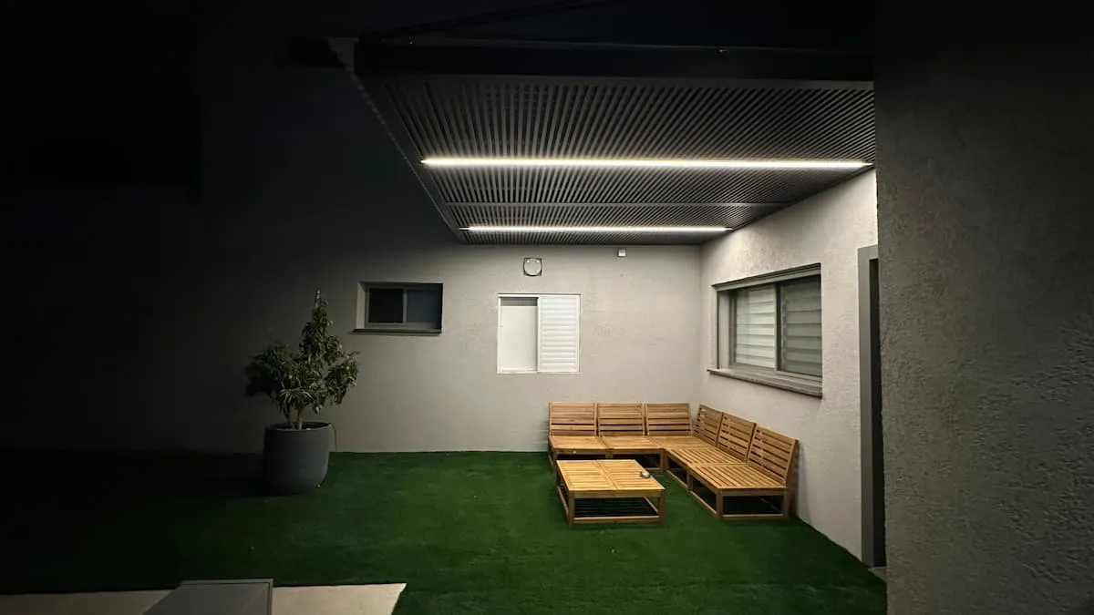Covered outdoor seating area illuminated at night